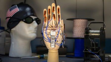 A hand mannequin with wires connected to a circuit board.